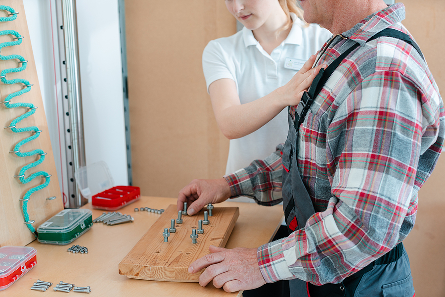 Worker In Occupational Therapy Re Learning To Lay Bricks In Real